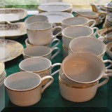 P62. Gold and white coffee cups with saucers. 9 large cups marked Pier 1 and 8 smaller unmarked cups. - $16 & 18 